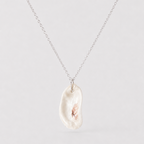 Necklace with a large, irregularly shaped pearl pendant on a light gray background