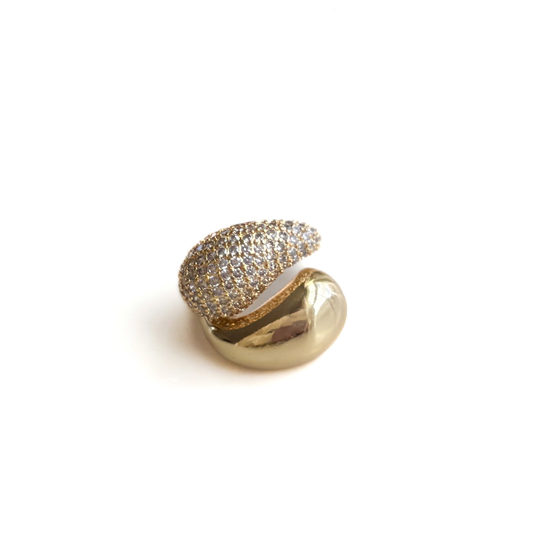 Gold heart-shaped jewelry piece with embedded stones on a white background
