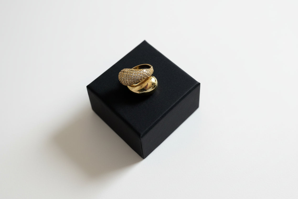 Gold ring on a black box with a gray background