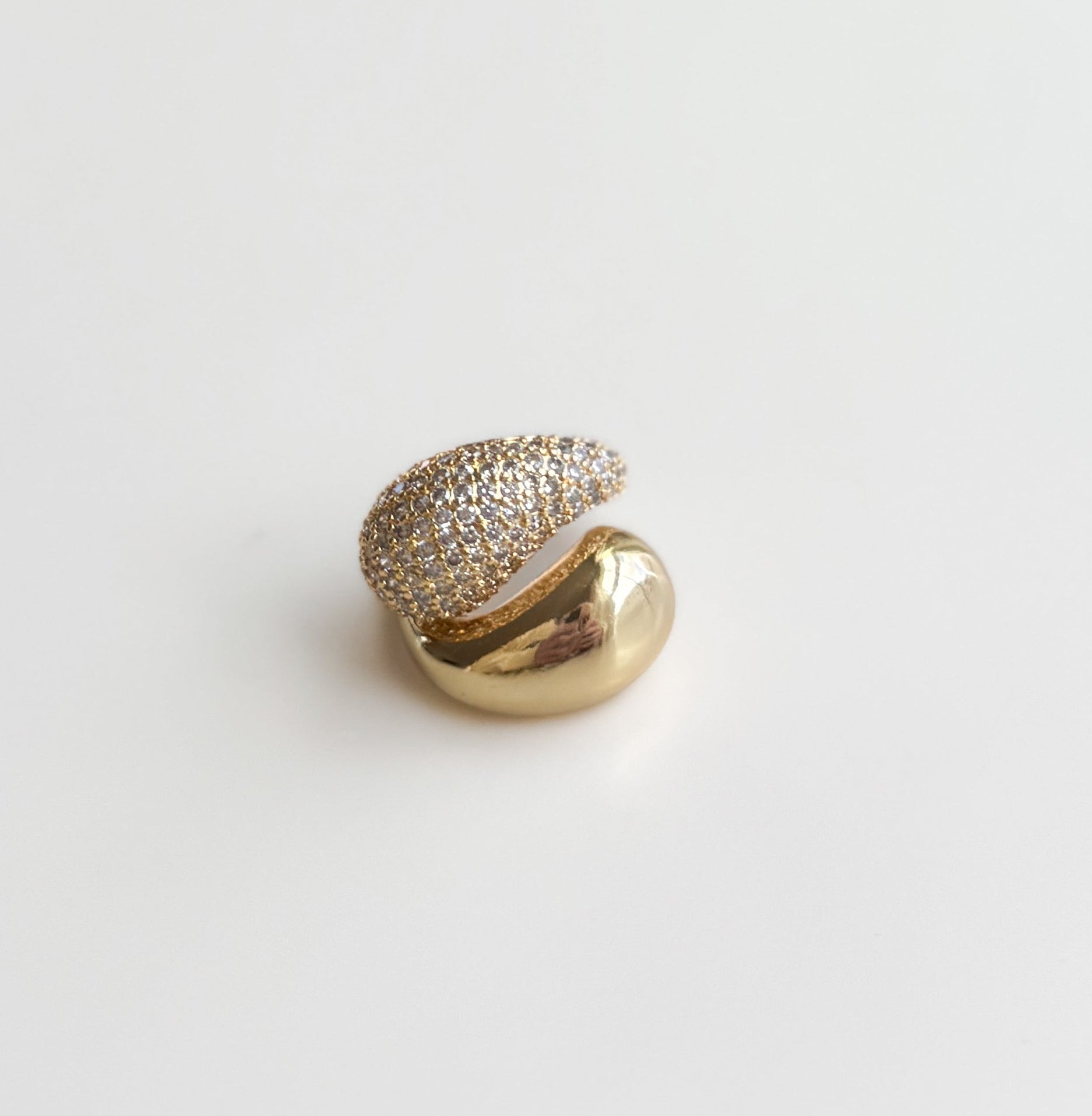 Ring with a green gemstone and gold accents on a white background