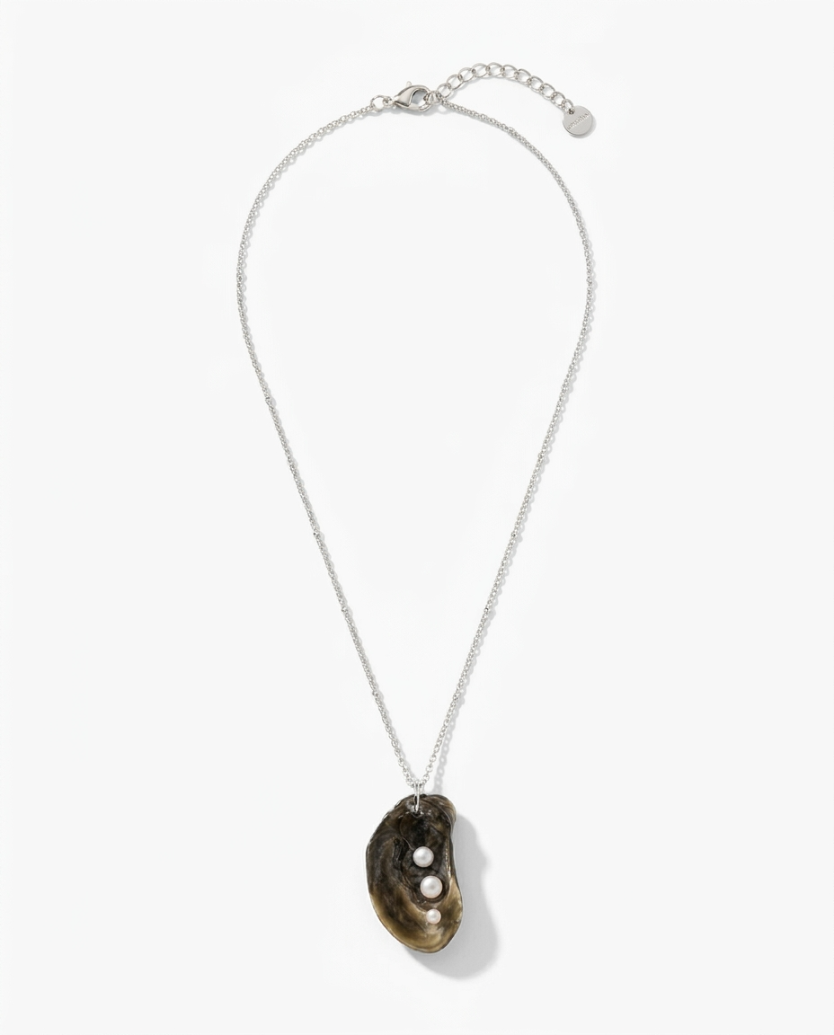 A silver chain necklace featuring a natural mussels shell pendant with three small white pearls, displayed on a clean white background.