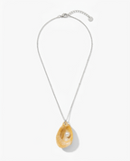 A silver chain necklace featuring a teardrop-shaped pendant made from a natural yellow oyster shell with a single white pearl nestled inside, shown against a clean white background.