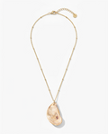 A gold chain necklace featuring a large, organic-shaped peach-colored stone pendant, displayed on a clean white background.