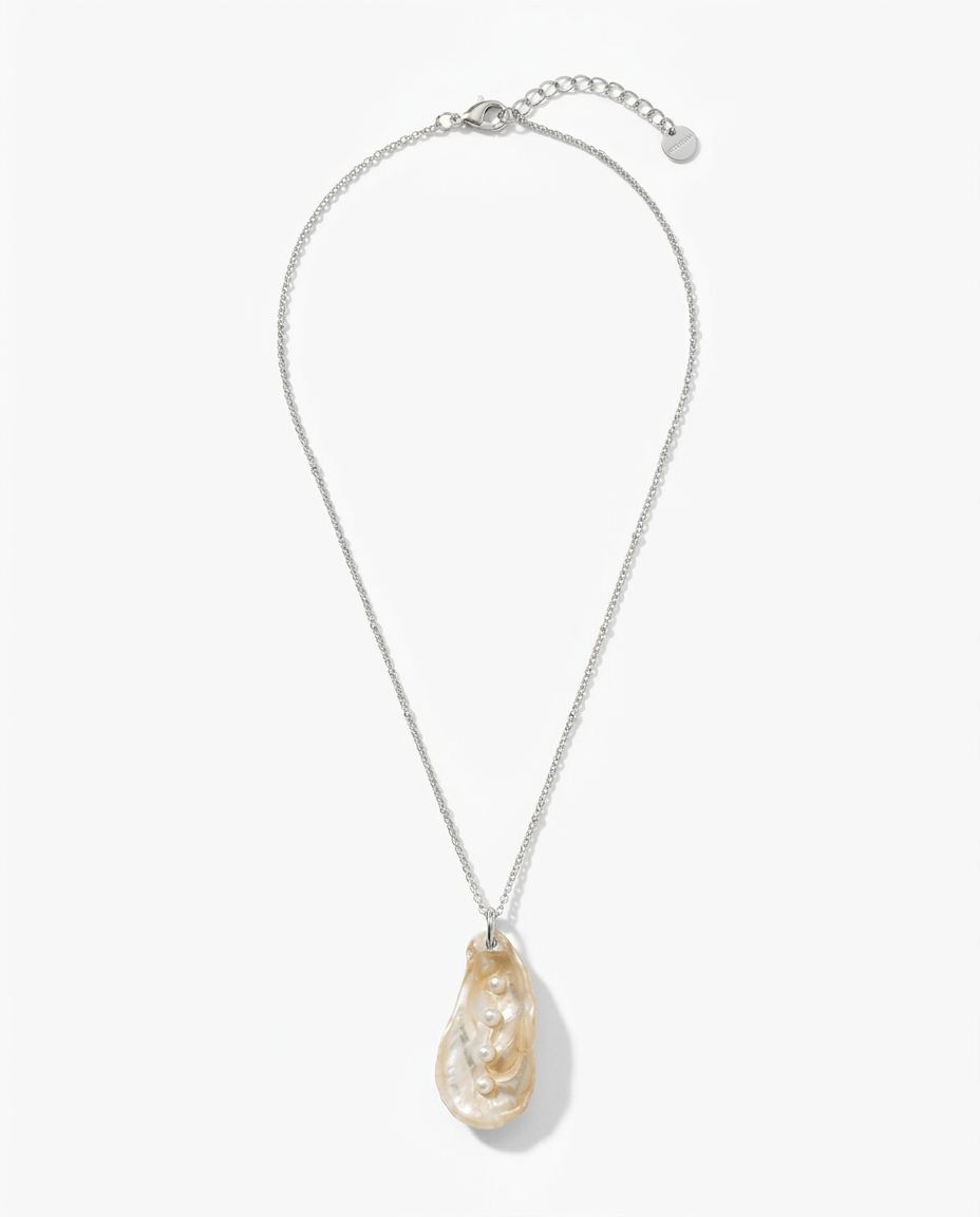 A silver chain necklace featuring a teardrop-shaped pendant made of natural iridescent pearl, shown against a light gray background.