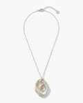 A silver chain necklace featuring a large, organic-shaped polished oyster shell pendant in a champagne or light beige tone, displayed against a clean white background.