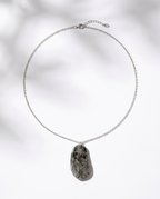 Necklace with a stone pendant on a light background